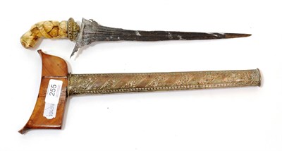 Lot 255 - An Early 20th Century Javanese Kris, with 29cm straight pamor blade, brass beaded and...