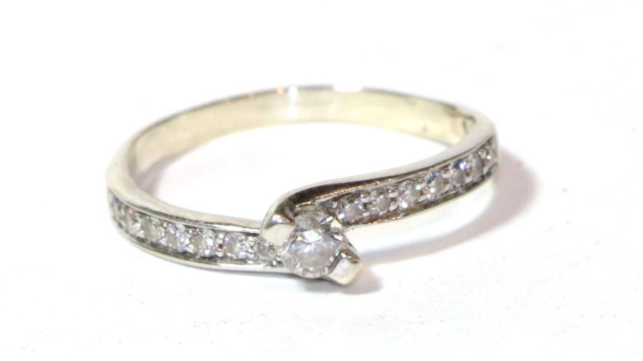 Lot 7 - A diamond solitaire ring with diamond set shoulders, stamped '14K', finger size L1/2