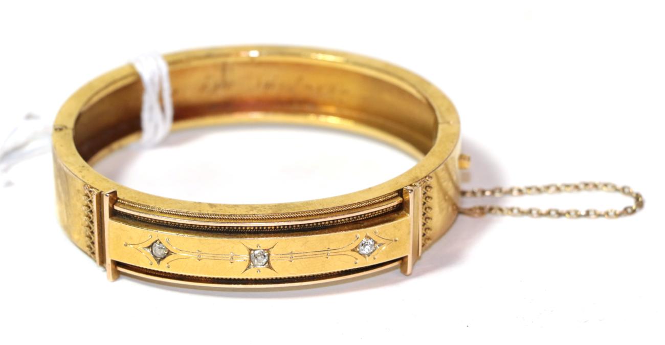 Lot 23 - A diamond set hinged bangle, unmarked, measures 5.6cm by 4.7cm