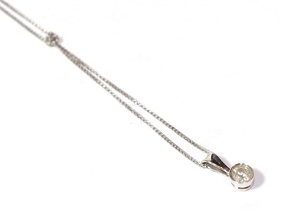Lot 46 - A 9 carat white gold diamond solitaire pendant on a trace link chain stamped '375', chain...