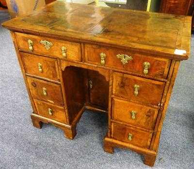 Lot 1202 - A George I Walnut Kneehole Desk, early 18th century, the quarter-veneered top above two frieze...