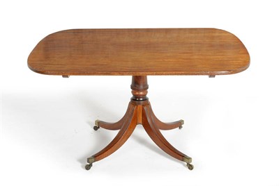 Lot 1203 - A George III Mahogany Breakfast Table, circa 1820, the rectangular reeded top above a turned...