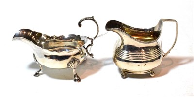 Lot 128 - A George III silver sauceboat and a George III silver cream-jug, the first by William and James...