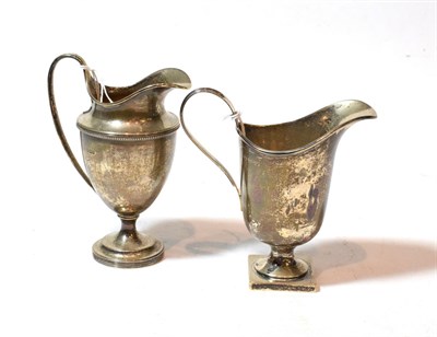Lot 130 - Two similar George V silver cream-jugs, both Sheffield, 1924, one by Mappin and Webb, the other...