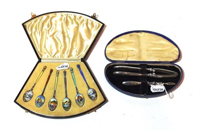 Lot 136 - A cased set of six George V enamelled silver teaspoons, two by Henry Clifford Davis,...