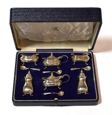 Lot 139 - A George V silver condiment-set, by Mappin and Webb, Birmingham, 1913, each piece square bombé and