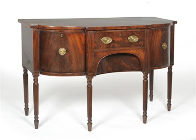 Lot 1210 - A Late George III Mahogany Breakfront Sideboard, early 19th century, the single frieze drawer above