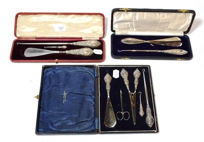 Lot 197 - A George V silver button-hook and shoe horn set, Birmingham, 1912, cased; with two other...