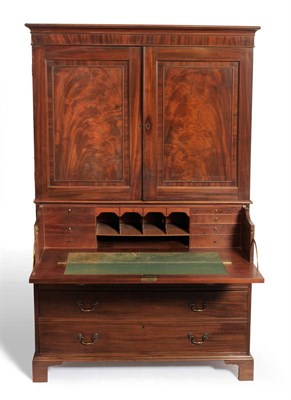 Lot 1213 - A George III Mahogany Secretaire Linen Press, circa 1800, with two panel doors enclosing four...