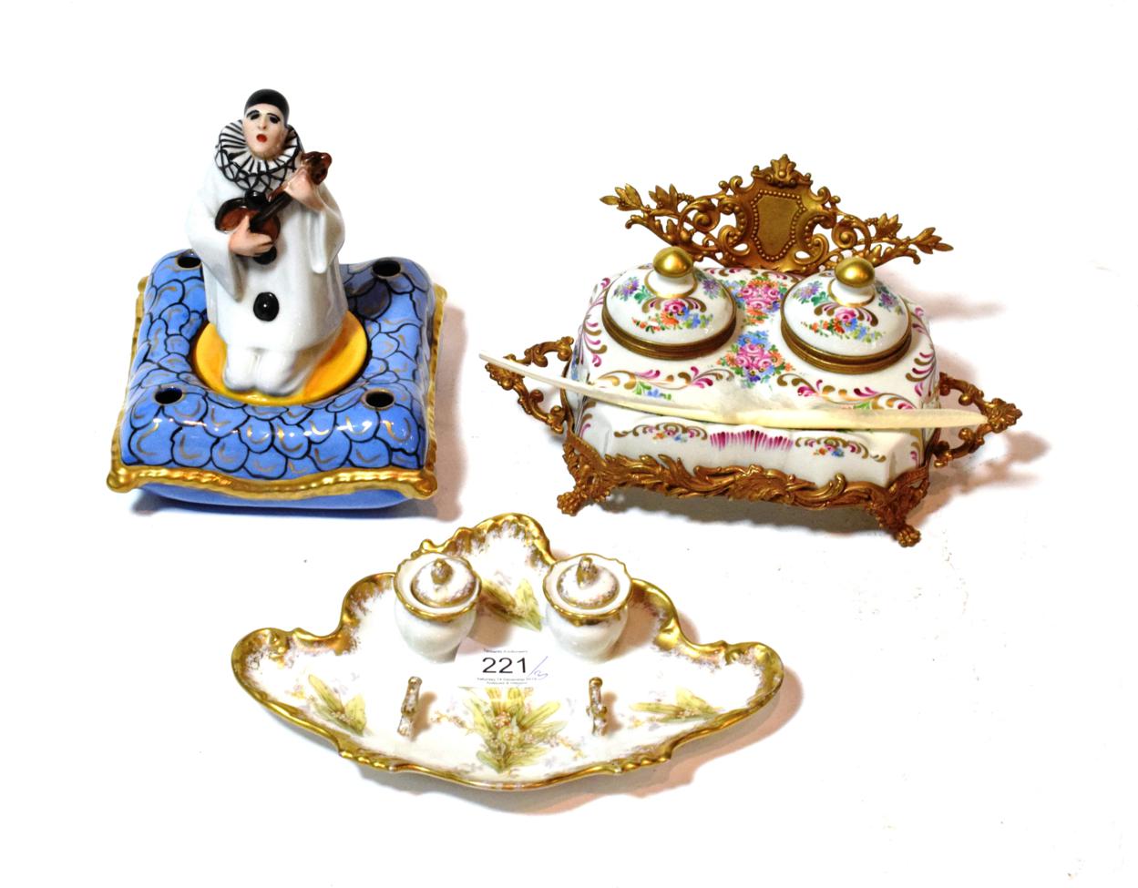 Lot 221 - An Art Deco Limoges figural inkwell, Pierrot with mandolin, 17cm high; with two others (3)