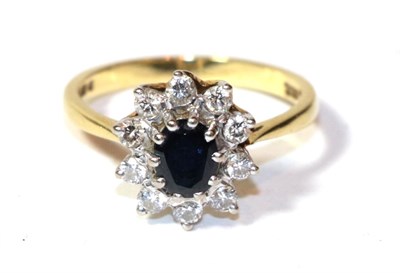 Lot 252 - An 18 carat gold diamond and sapphire cluster ring, finger size M1/2