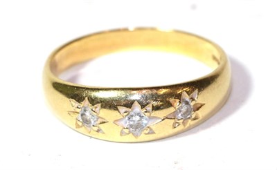 Lot 254 - An 18 carat gold diamond three stone ring, finger size X