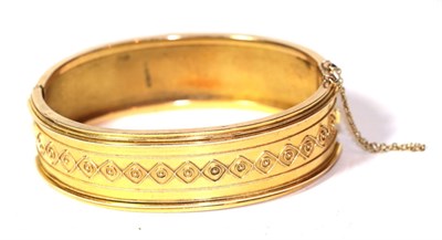 Lot 258 - A 15 carat gold hinged bangle, measures 6cm by 4.7cm
