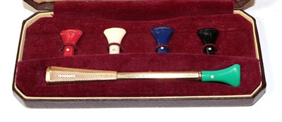 Lot 265 - A 9 carat gold Dunhill cigarette holder with five interchangeable coloured mouth pieces, in...
