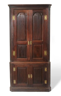 Lot 1221 - A George III Mahogany Freestanding Corner Cupboard, late 18th century, with conforming double...