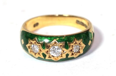 Lot 287 - An 18 carat green enamel and diamond three stone ring, finger size N