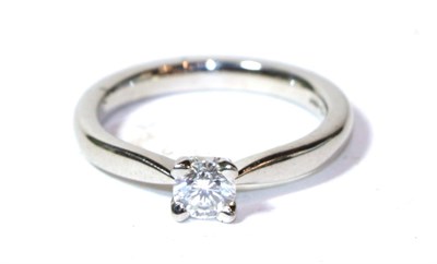 Lot 297 - A platinum diamond solitaire ring, a round brilliant cut diamond in a claw setting, to a...