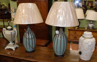 Lot 311 - A pair of large green pottery table lamps with silk shades, and two other ceramic lamps (4)