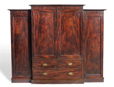 Lot 1224 - A George III Mahogany Breakfront Dwarf Linen Press, circa 1800, the bold pediment above two...