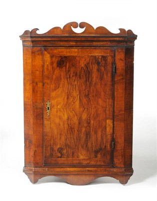 Lot 1229 - A George II Walnut and Featherbanded Straight Front Hanging Corner Cupboard, mid 18th century,...