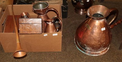 Lot 387 - A collection of copper ware to include a four gallon jug and measuring jugs; hunting horns;...