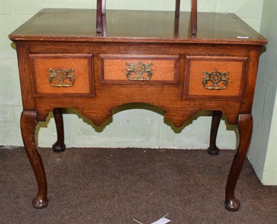 Lot 423 - A George III oak crossbanded dressing table with later brass handles, 85cm wide