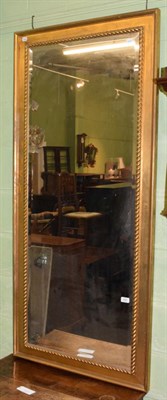 Lot 430 - A gilt framed bevelled glass mirror with rope twist border, 166cm by 75cm