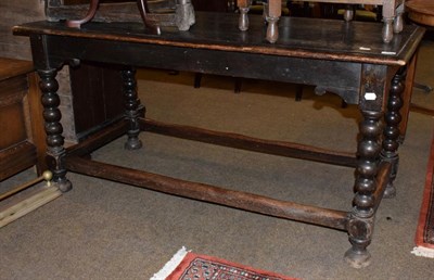 Lot 443 - A small oak refectory table on turned legs joined by a stretcher, 142cm wide