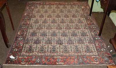 Lot 451 - Bakhtiari Rug, West Iran, circa 1940, the cream field with rows of urns issuing flowers enclosed by