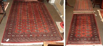 Lot 452 - A Lahore Bokhara rug, the terracotta field with columns of quartered guls, enclosed by...