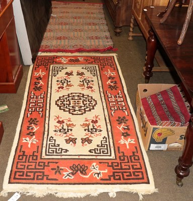 Lot 453 - A Moroccan Berber flat weave rug, the blood red field with narrow geometric bands, enclosed by...