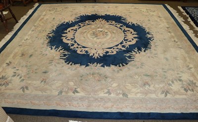 Lot 455 - A Chinese carpet of unusual size, the indigo field centred by a floral medallion, framed by...