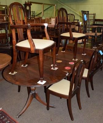 Lot 468 - A reproduction twin pedestal dining table with six chairs (including two carvers)