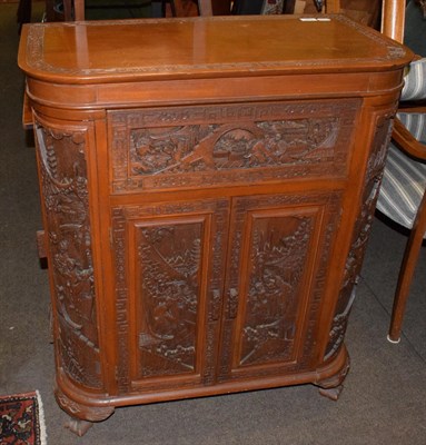 Lot 473 - A 20th century carved hardwood drinks cabinet