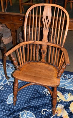 Lot 485 - An ash and elm Windsor chair with crinoline stretcher, bearing old paper label