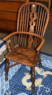 Lot 486 - An elm seated Windsor chair, pierced splat, crinoline stretcher