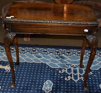 Lot 487 - A mahogany fold over card table, green baize inset, carved cabriole legs