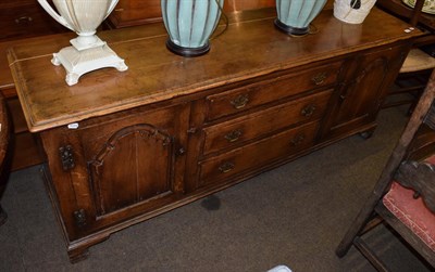 Lot 498 - A reproduction oak sideboard in the 18th century style, 197cm wide