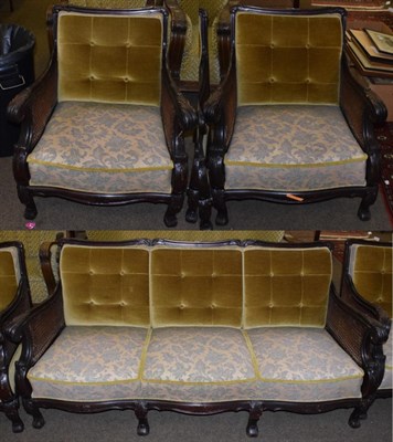 Lot 502 - An early 20th century Danish three-piece bergere suite, double caned acanthus carved scrollwork...