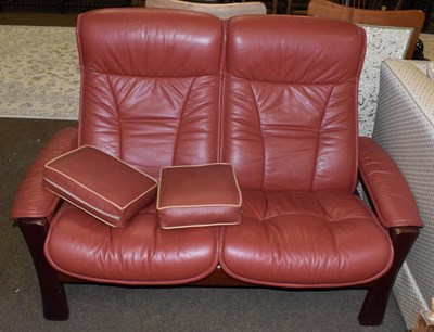 Lot 507 - An Ekornes stressless two-seater sofa, modern, the stained beech frame and reclining seats with...