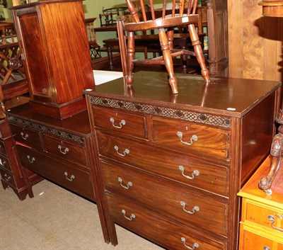 Lot 523 - An early 20th century mahogany five drawer chest with blind fret carving; a matching three...