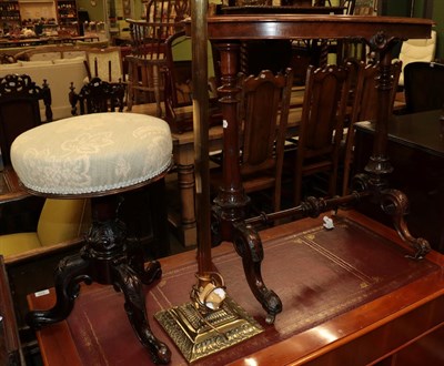 Lot 527 - A Victorian walnut side table of oval form; with a 19th century piano stool; and a standard...