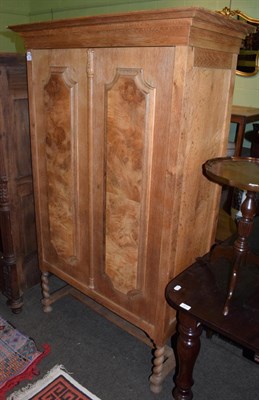 Lot 530 - A Danish oak two door cabinet, walnut veneer panels, integral cornice, barley twist supports, 173cm