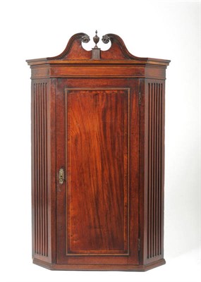 Lot 1244 - A George III Mahogany, Boxwood and Herringbone Banded Corner Cupboard, late 18th century, with...