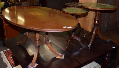 Lot 534 - A reproduction oval coffee table; together with three reproduction wine tables (4)