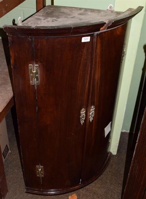 Lot 537 - A George III mahogany bow fronted hanging corner cupboard