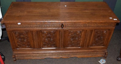 Lot 545 - A joined oak chest with hinged lid above four carved panels, 133cm wide