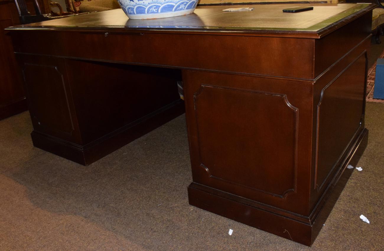 Lot 551 - A reproduction leather top desk, 183cm wide