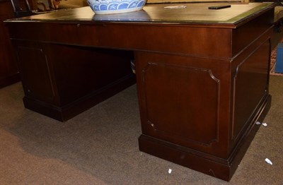 Lot 551 - A reproduction leather top desk, 183cm wide