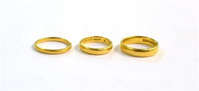 Lot 399 - Three 22 carat gold band rings, finger sizes J, L1/2 and N